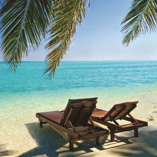 Wooden sun loungers on the beach over looking crystal clear waters