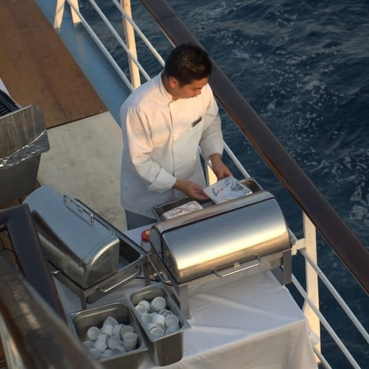 Chef preparing a meal on deck