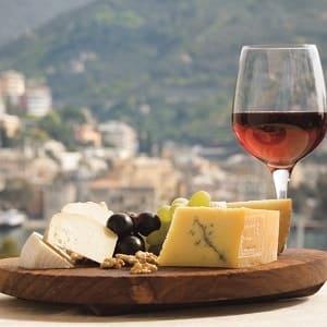 Cheese and wine on a table overlooking Italy