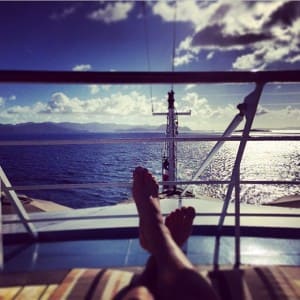 Guest reclining on deck with a view of the sea