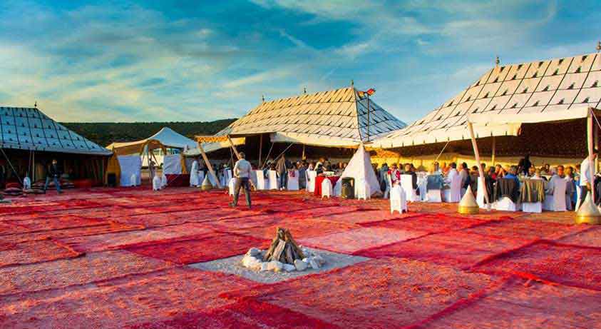 Guests enjoying dinner under tents in Morocco
