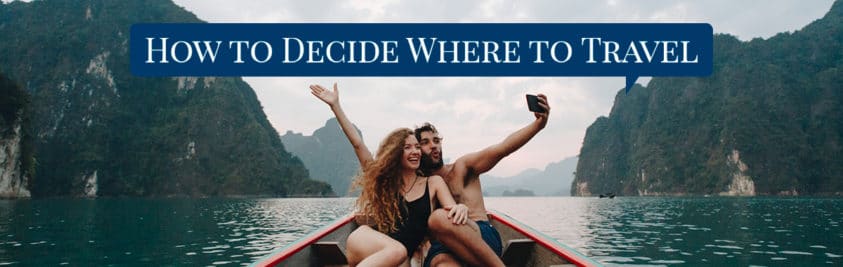 Couple taking a selfie in a small boat surrounded by cliffs