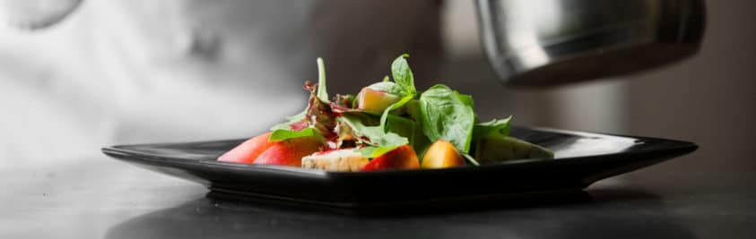 Gourmet food served on a black plate