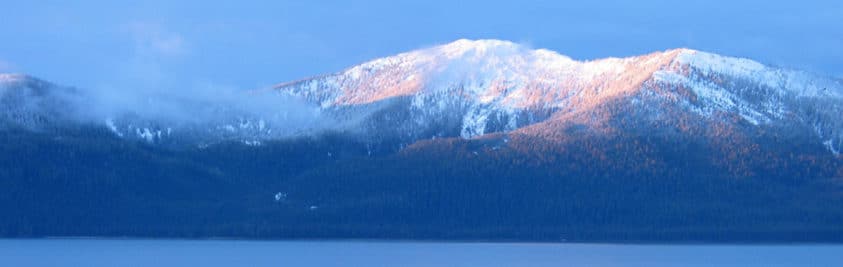 snow capped mountains covered in clouds