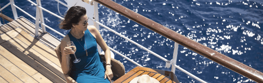 Woman drinking wine on a cruise ship