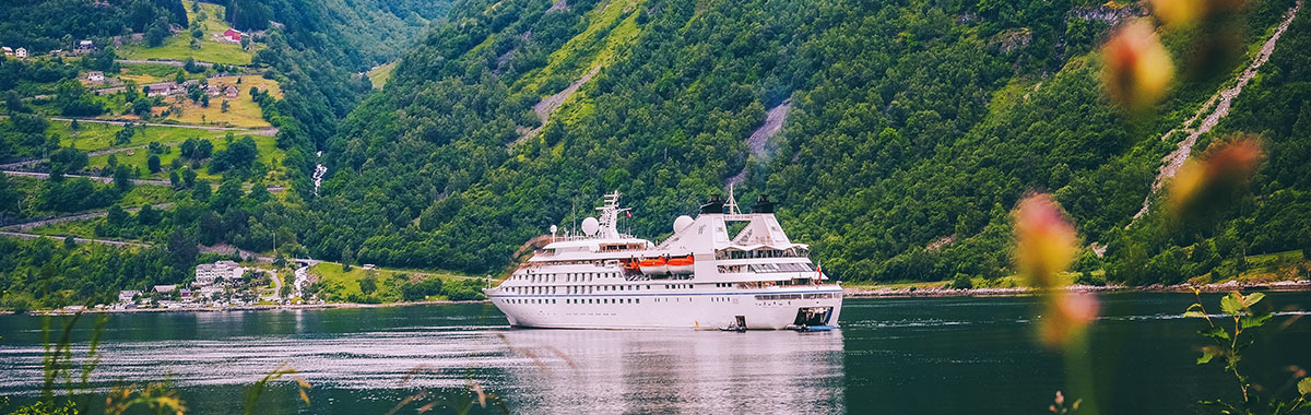 Windstar Cruise ship with green hills in the background
